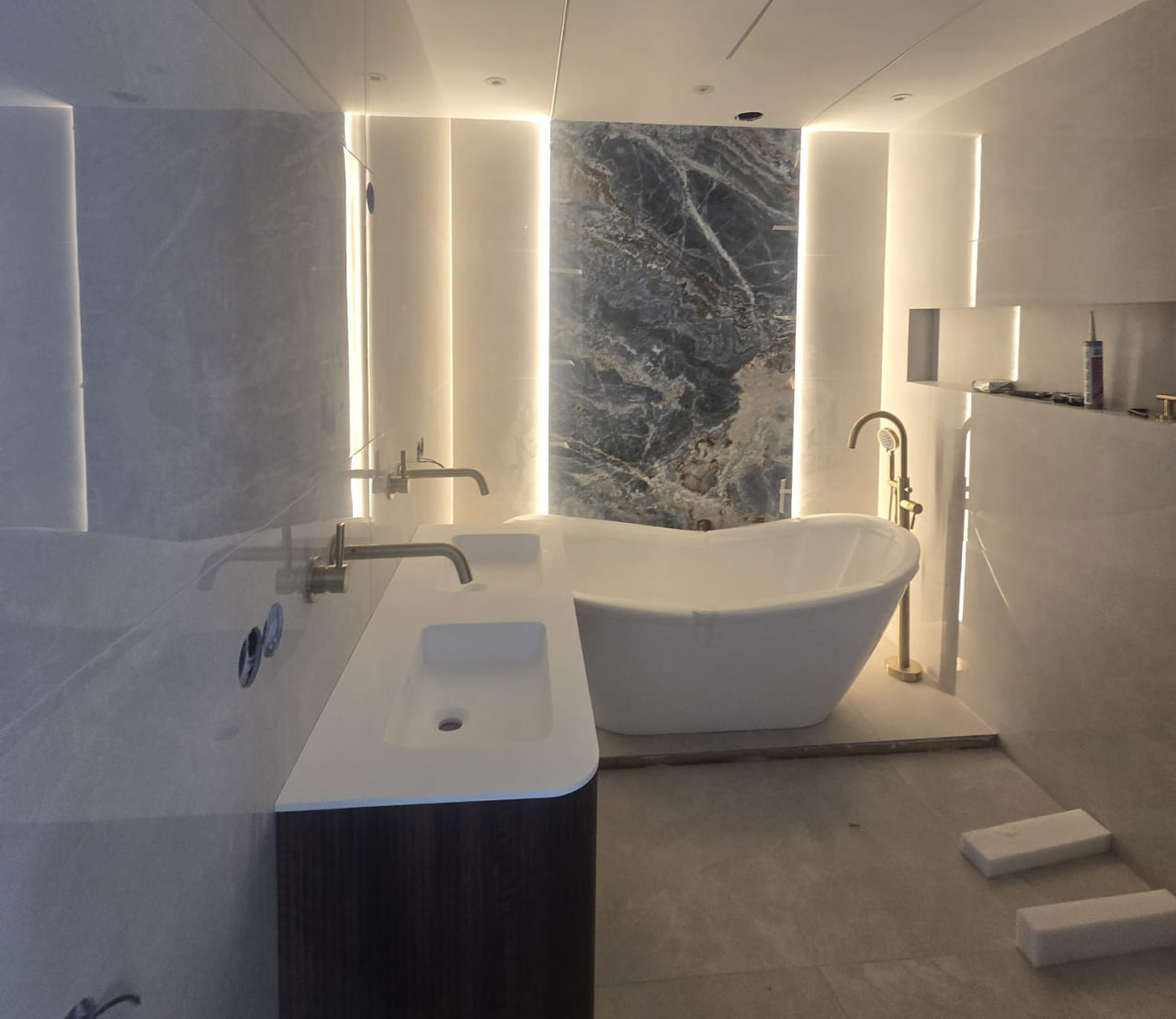 Modern walk-in shower with large-format tiles in a Rotterdam apartment